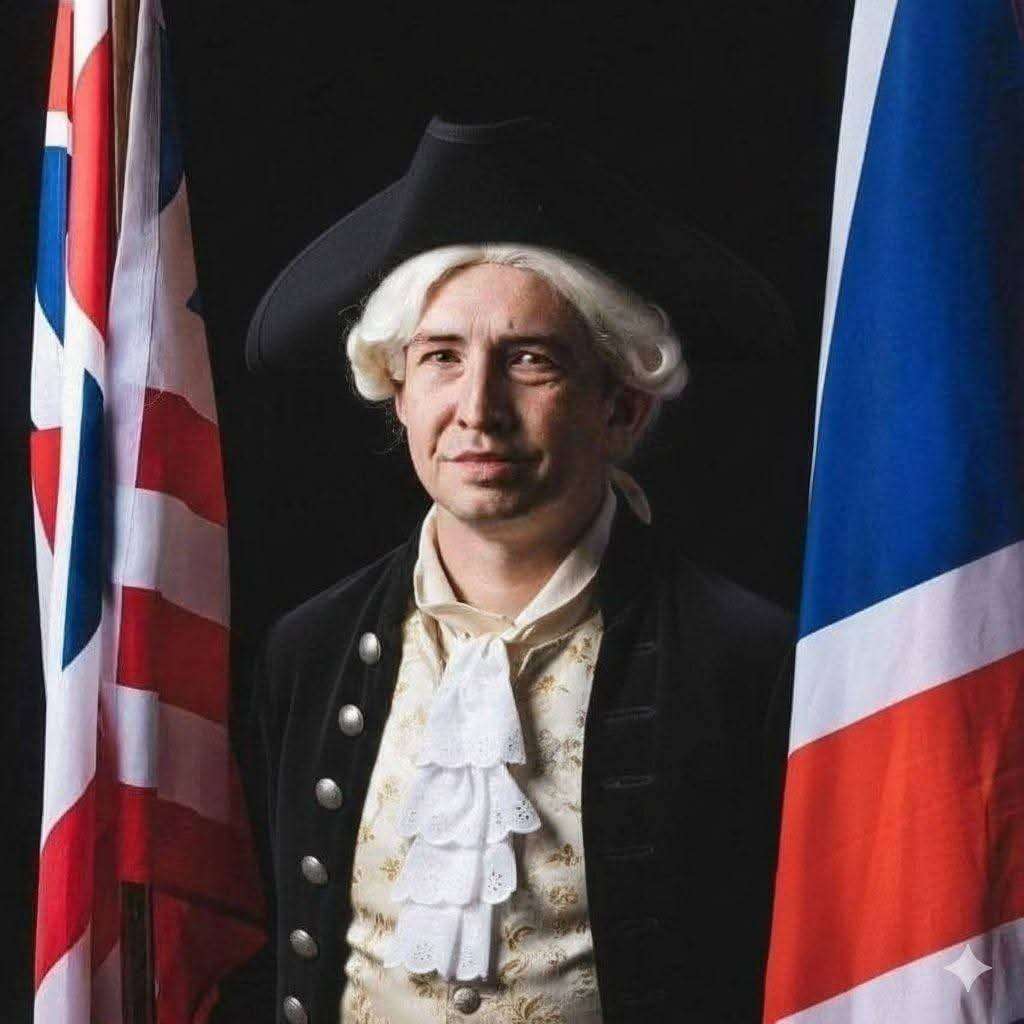 DeVaughn Simper dresses in colonial garb between historic flags at an event in July of 2025.