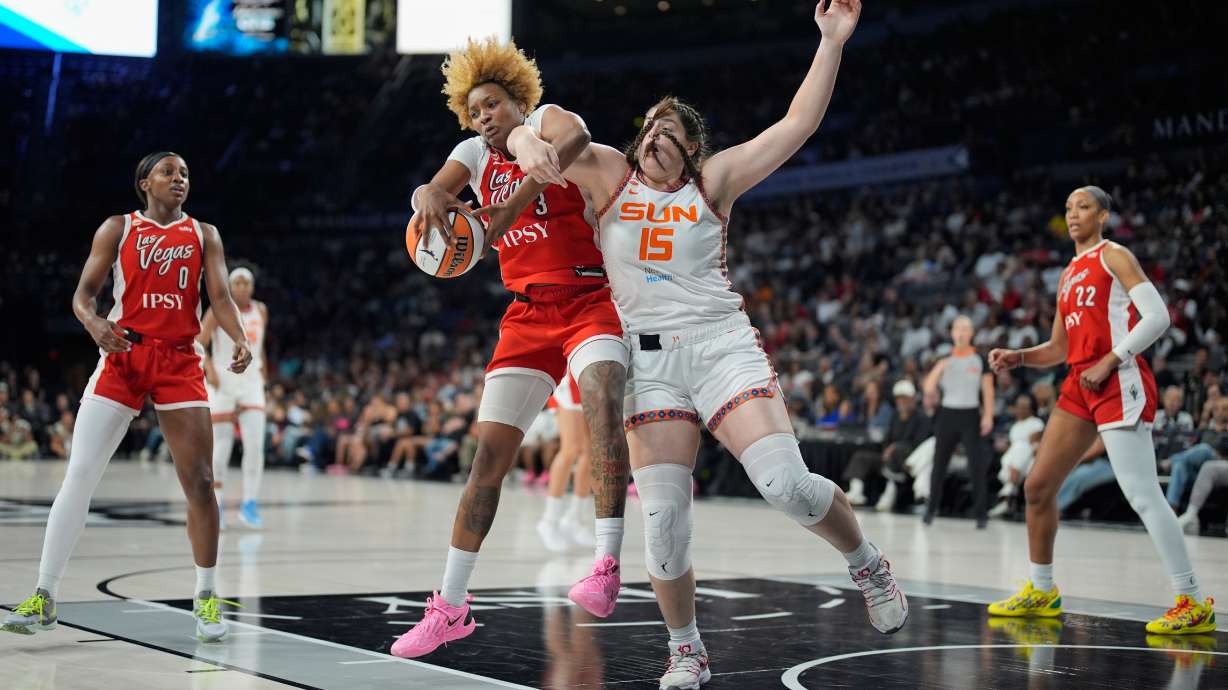 Las Vegas Aces forward NaLyssa Smith (3) and Connecticut Sun forward Raegan Beers (15) battle for the ball during the first half of a WNBA basketball game Thursday, Aug. 20, 2026, in Las Vegas.