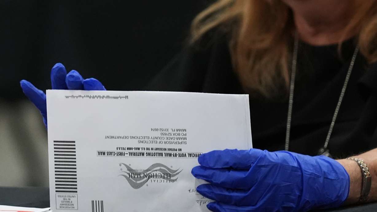 An election worker sorts vote-by-mail ballots at the Miami-Dade County Supervisor of Elections Office for the Florida primary election in Doral, Fla., Aug. 18.