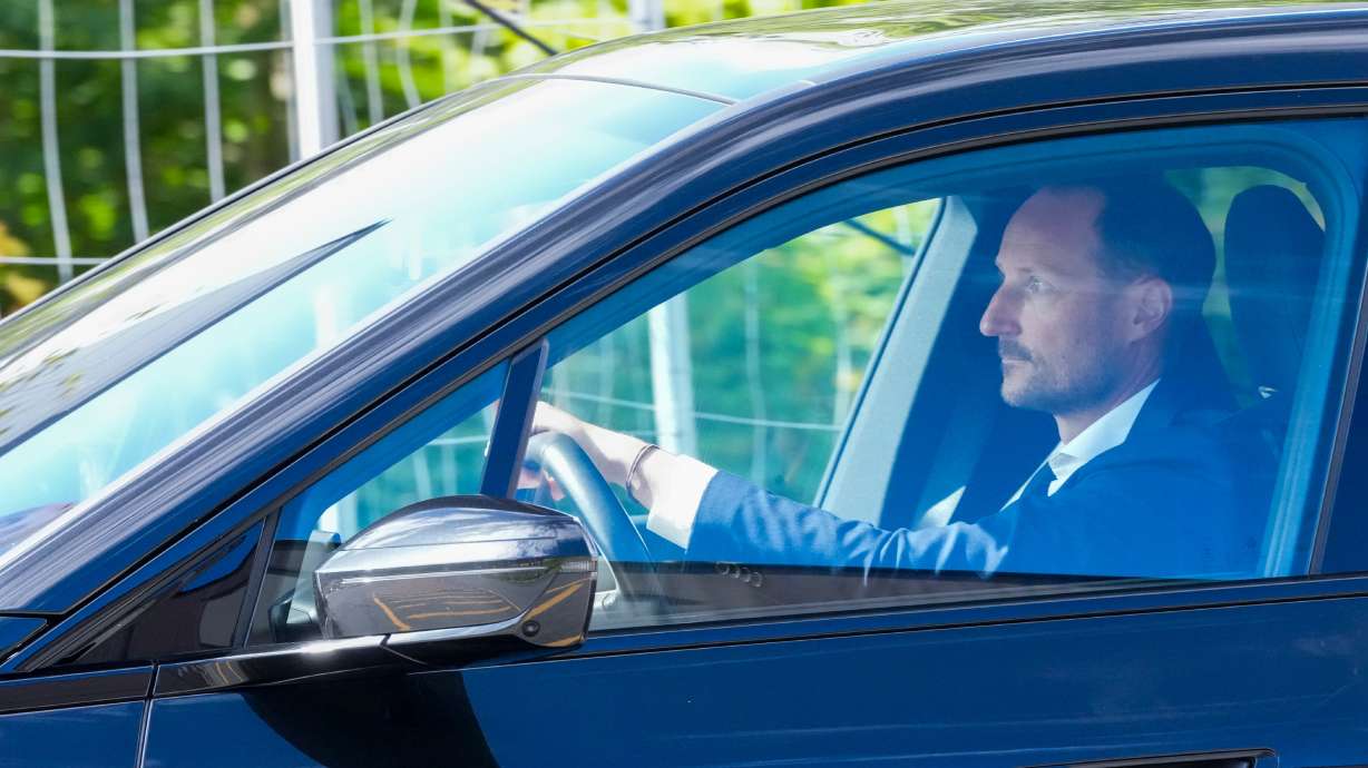 Norwegian Crown Prince Haakon drives a car on his way to the National Hospital in Oslo on Monday. Haakon has ascended to the throne following the death of his father, King Harald V.