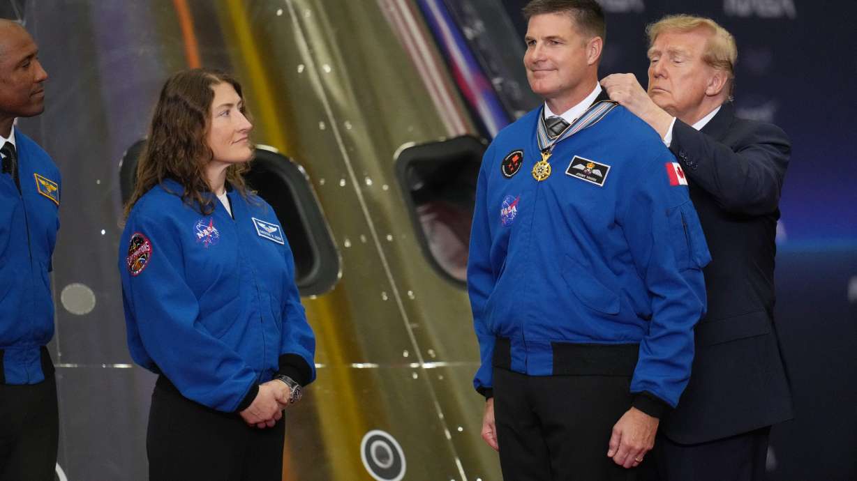 Pres. Donald Trump participates in a Congressional Space Medal of Honor ceremony at NASA's Johnson Space Center on Friday in Houston, and puts a medal on Artemis II Astronaut and Mission Specialist Jeremy Hansen.