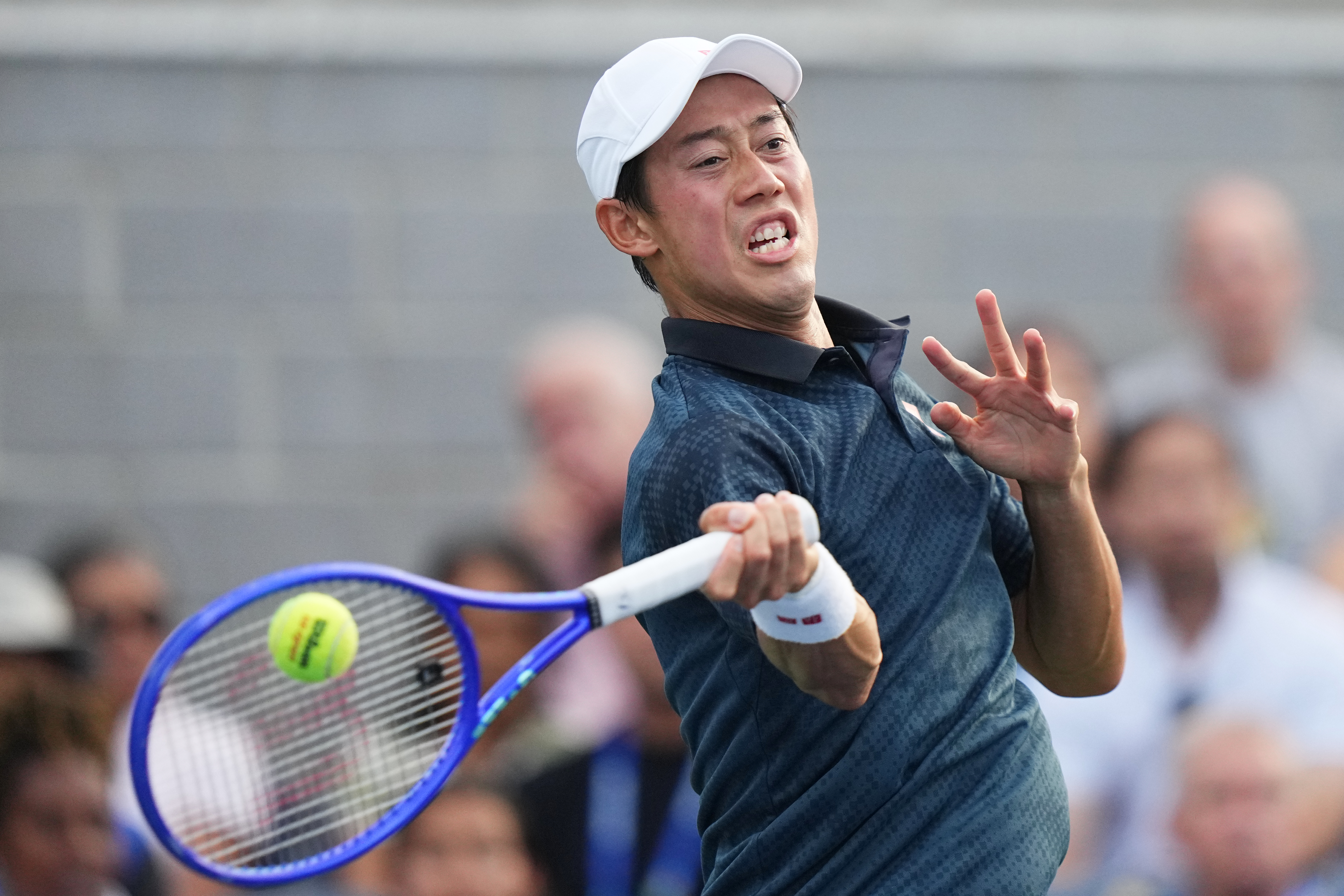 Kei Nishikori, of Japan, returns the ball to Michael Antonius, of the United States, during a qualifying match at the U.S. Open tennis championships Wednesday, Aug. 26, 2026, in New York. 