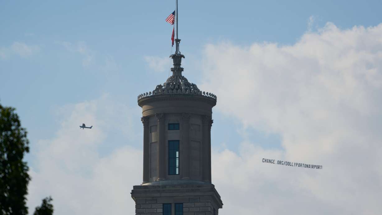 A plane flies over Nashville, Tenn., towing a banner reading “change.org/DollyPartonAirport” as part of an effort to rename the airport after Dolly Parton, Friday.