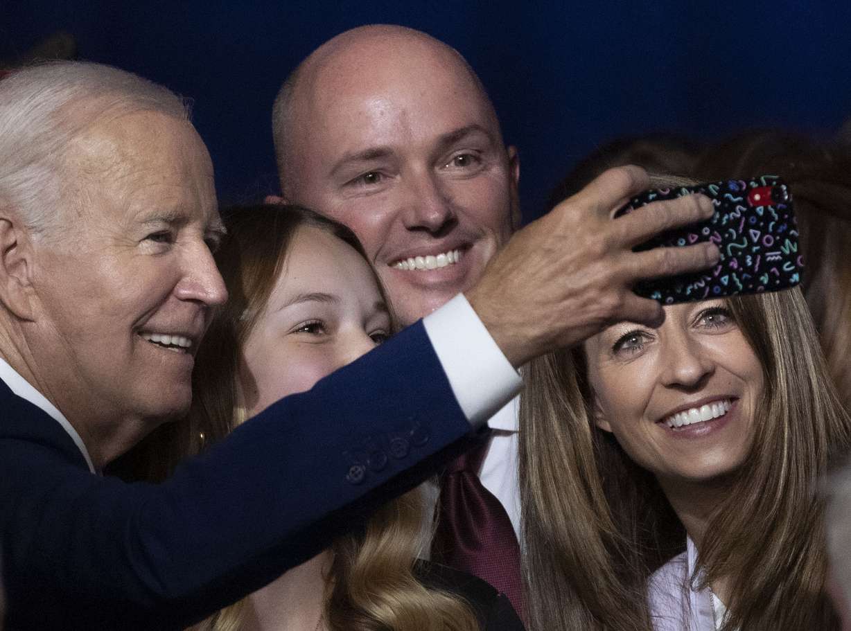 President Joe Biden takes a photo with Emma Kate Cox, Gov. Spencer Cox and first lady Abby Cox after speaking at the George E. Wahlen Department of Veterans Affairs Medical Center in Salt Lake City on Aug. 10, 2023.