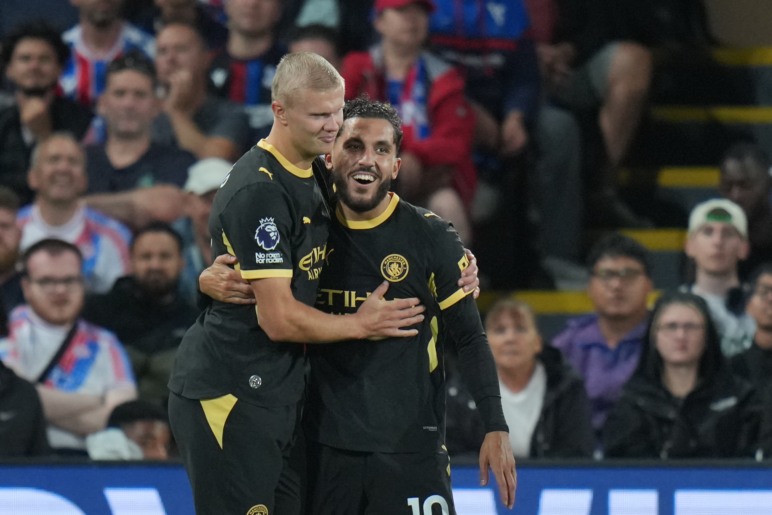 Manchester City's Rayan Cherki, right, celebrates with Erling Haaland after scoring his side's third goal during the English Premier League soccer match between Crystal Palace and Manchester City in London, Friday, Aug. 28, 2026. 