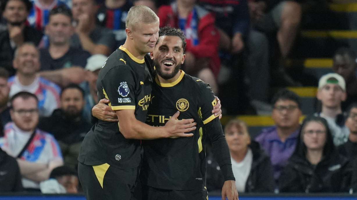 Manchester City's Rayan Cherki, right, celebrates with Erling Haaland after scoring his side's third goal during the English Premier League soccer match between Crystal Palace and Manchester City in London, Friday, Aug. 28, 2026.