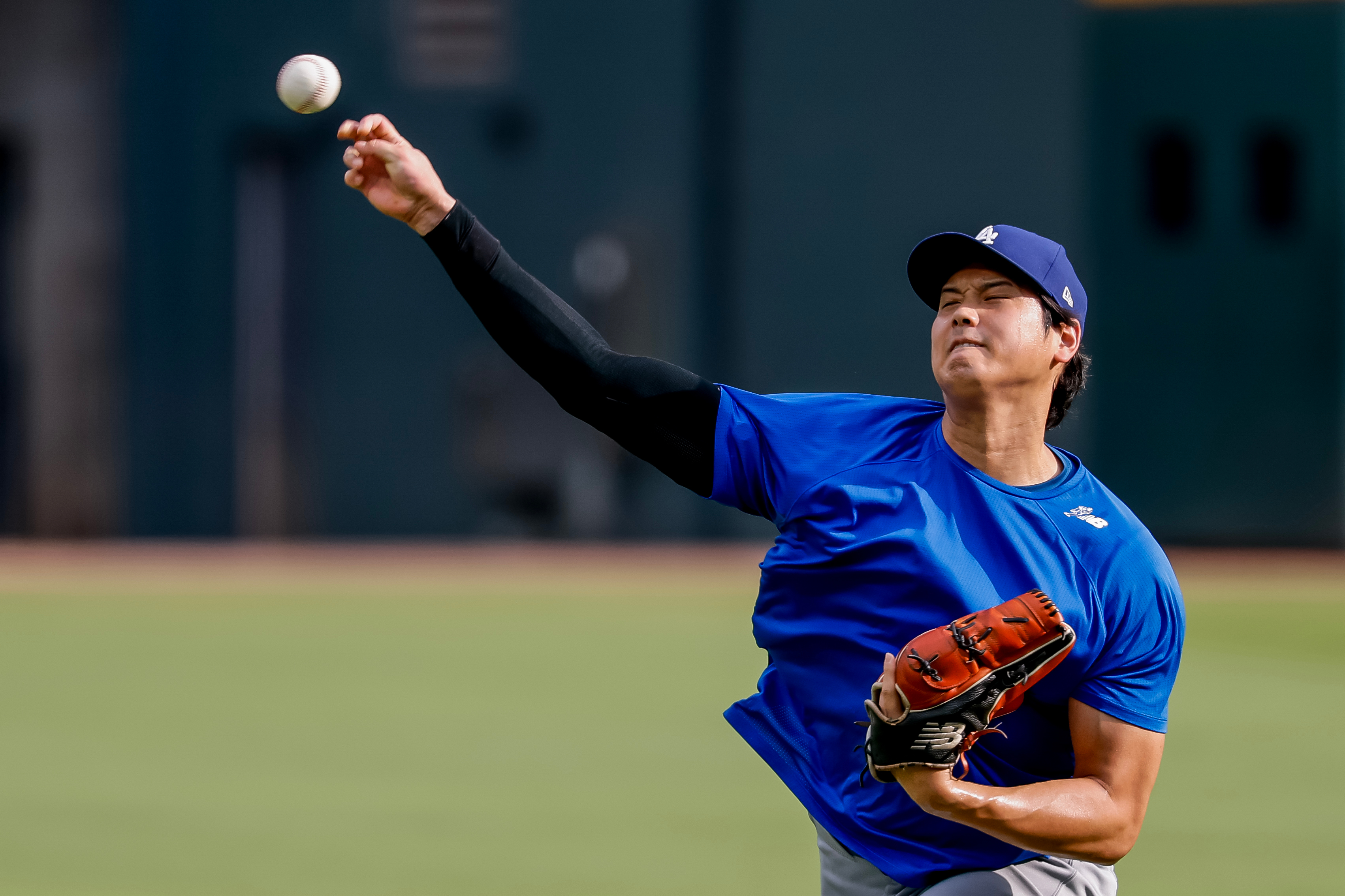 Los Angeles Dodgers pitcher Shohei Ohtani throws a practice session in the outfield before a baseball game against the Atlanta Braves, Thursday, Aug. 27, 2026, in Atlanta. 