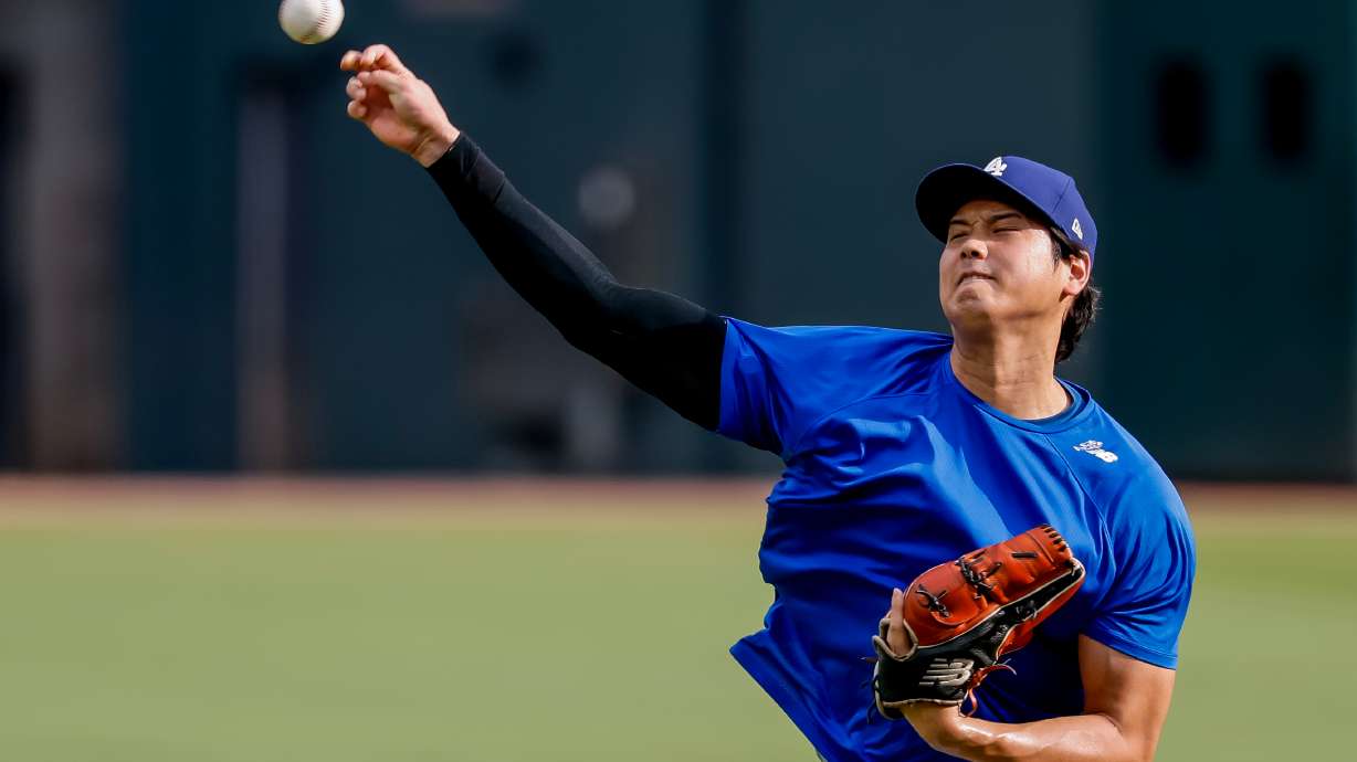 Los Angeles Dodgers pitcher Shohei Ohtani throws a practice session in the outfield before a baseball game against the Atlanta Braves, Thursday, Aug. 27, 2026, in Atlanta.