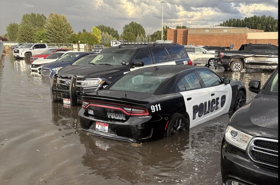 Waters flood around police cars at a Rexburg police station on Thursday, Aug. 27, 2026. Parts of Rexburg saw a huge downpour of rain Thursday evening that resulted in large puddles of water and flooding in some areas.
