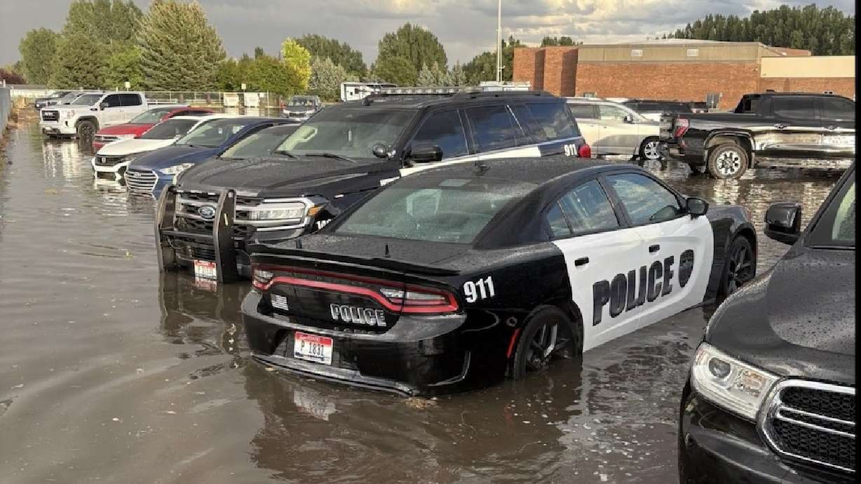 Waters flood around police cars at a Rexburg police station on Thursday, Aug. 27, 2026. Parts of Rexburg saw a huge downpour of rain Thursday evening that resulted in large puddles of water and flooding in some areas.