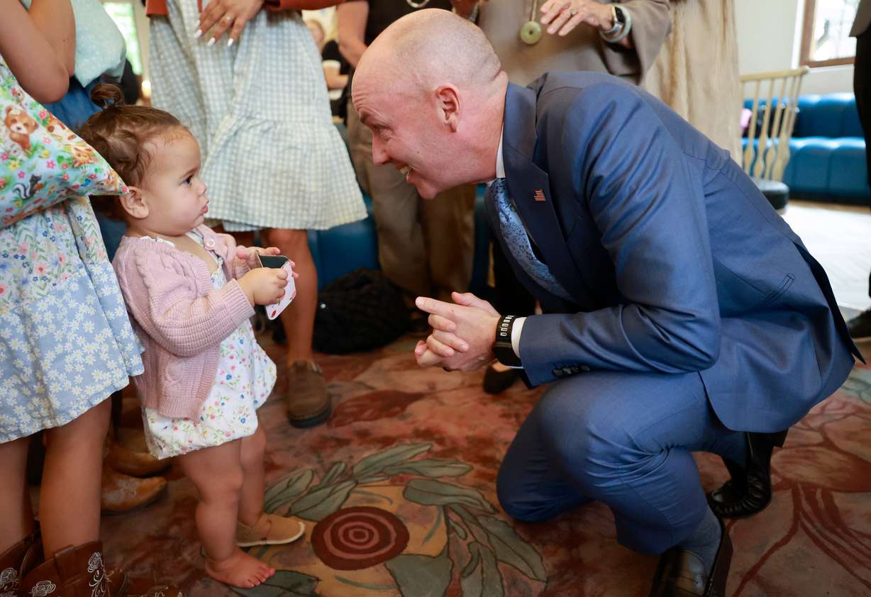 Ofelia Taylor, 1, looks at Gov. Spencer Cox at the launch of Utah Reads, a statewide early literacy initiative, at the Sprague branch of the Salt Lake City Public Library in Salt Lake City on Aug. 28.