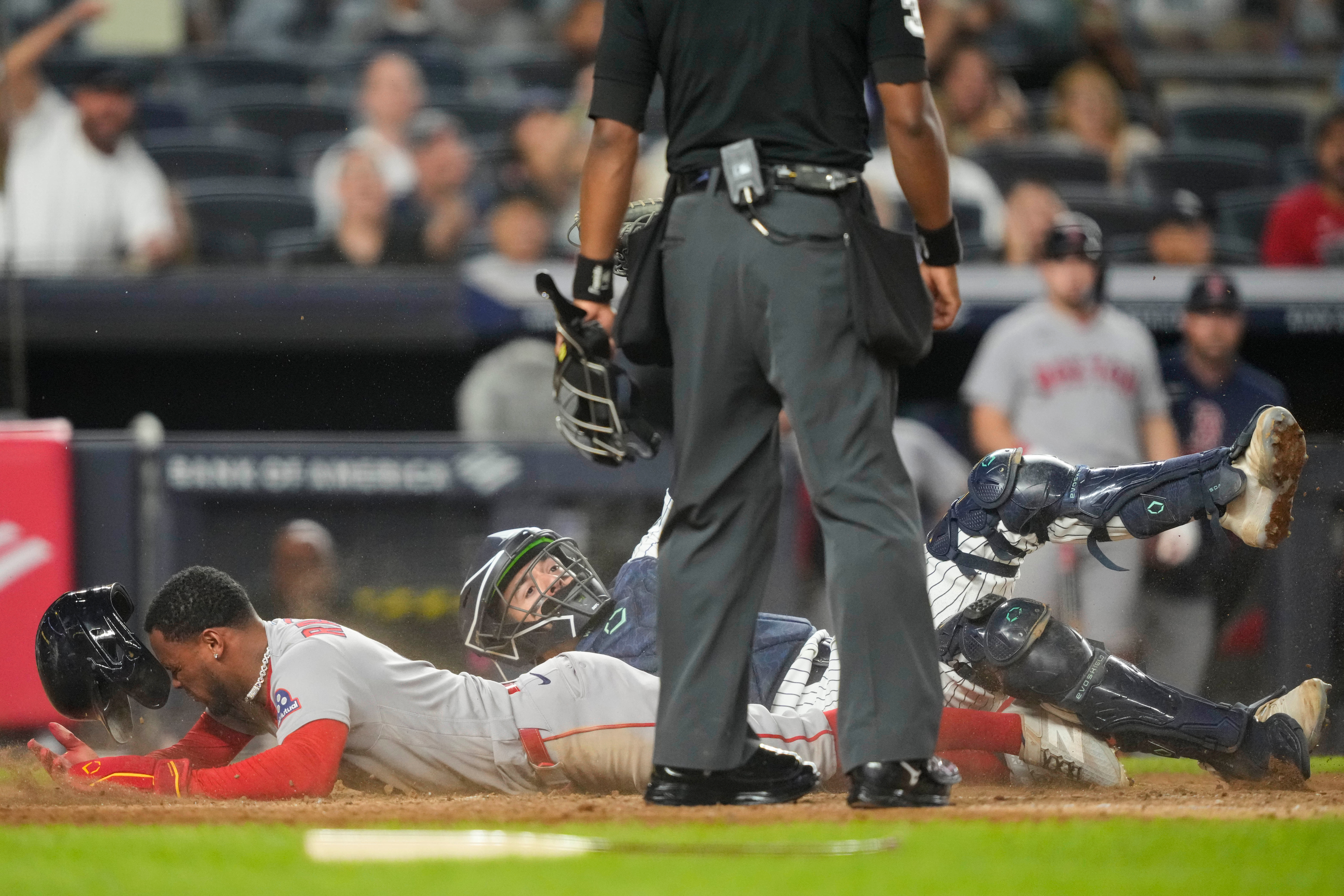 Boston Red Sox' Ceddanne Rafaela is tagged out by New York Yankees catcher Austin Wells at home plate on a double play during the seventh inning of a baseball game, Friday, Aug. 28, 2026, in New York. 