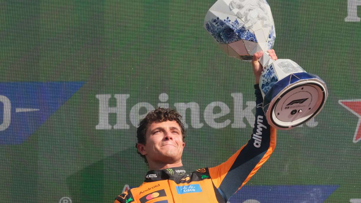 McLaren driver Lando Norris of Britain holds the trophy after winning the Formula One Dutch Grand Prix in Zandvoort , Netherlands, Sunday, Aug. 23, 2026.