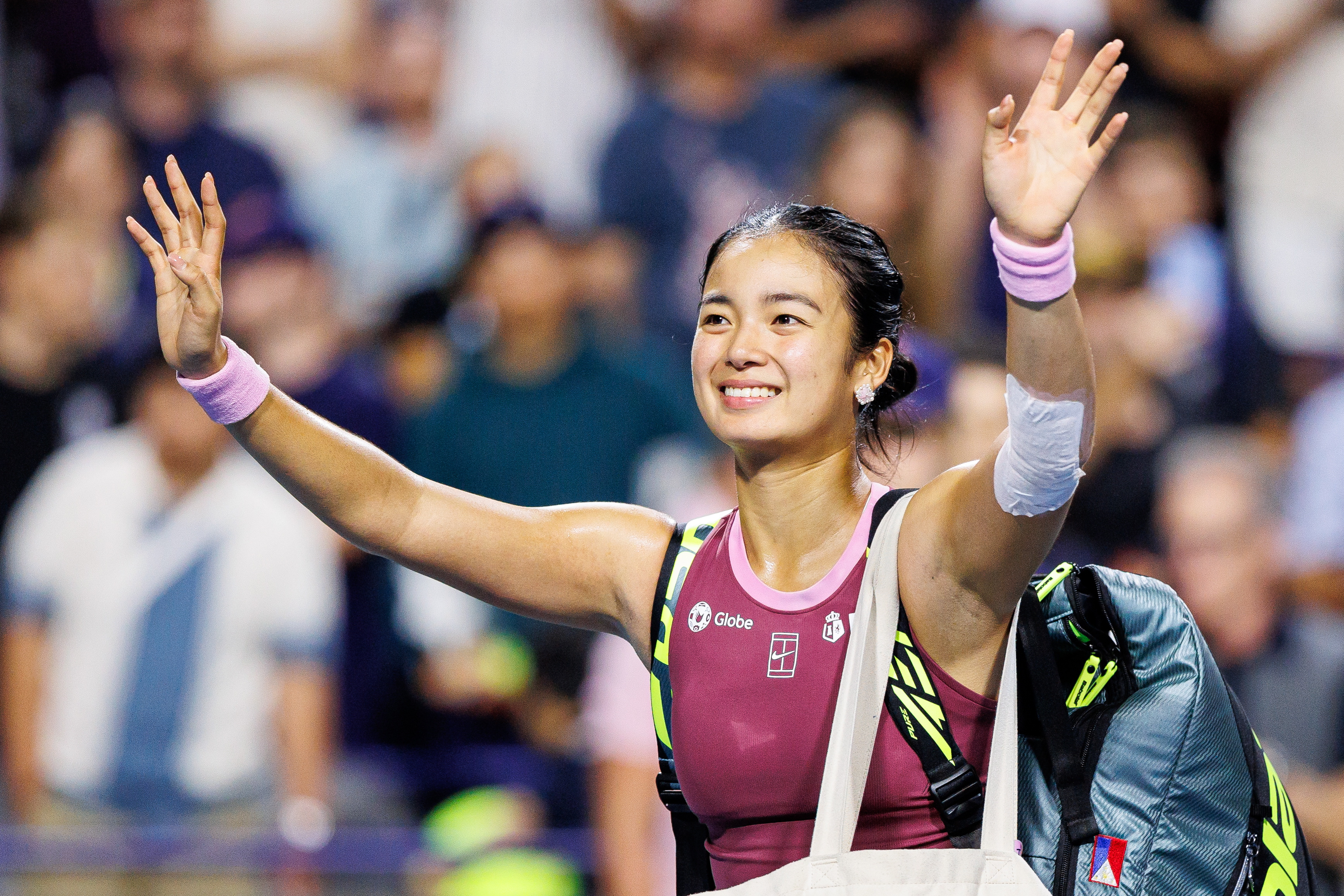 Alexandra Eala, of the Philippines, waves to the crowd after losing to Belinda Bencic, of Switzerland, in a round of 16 match at the National Bank Open tennis tournament in Toronto, on Sunday, Aug. 9, 2026. 