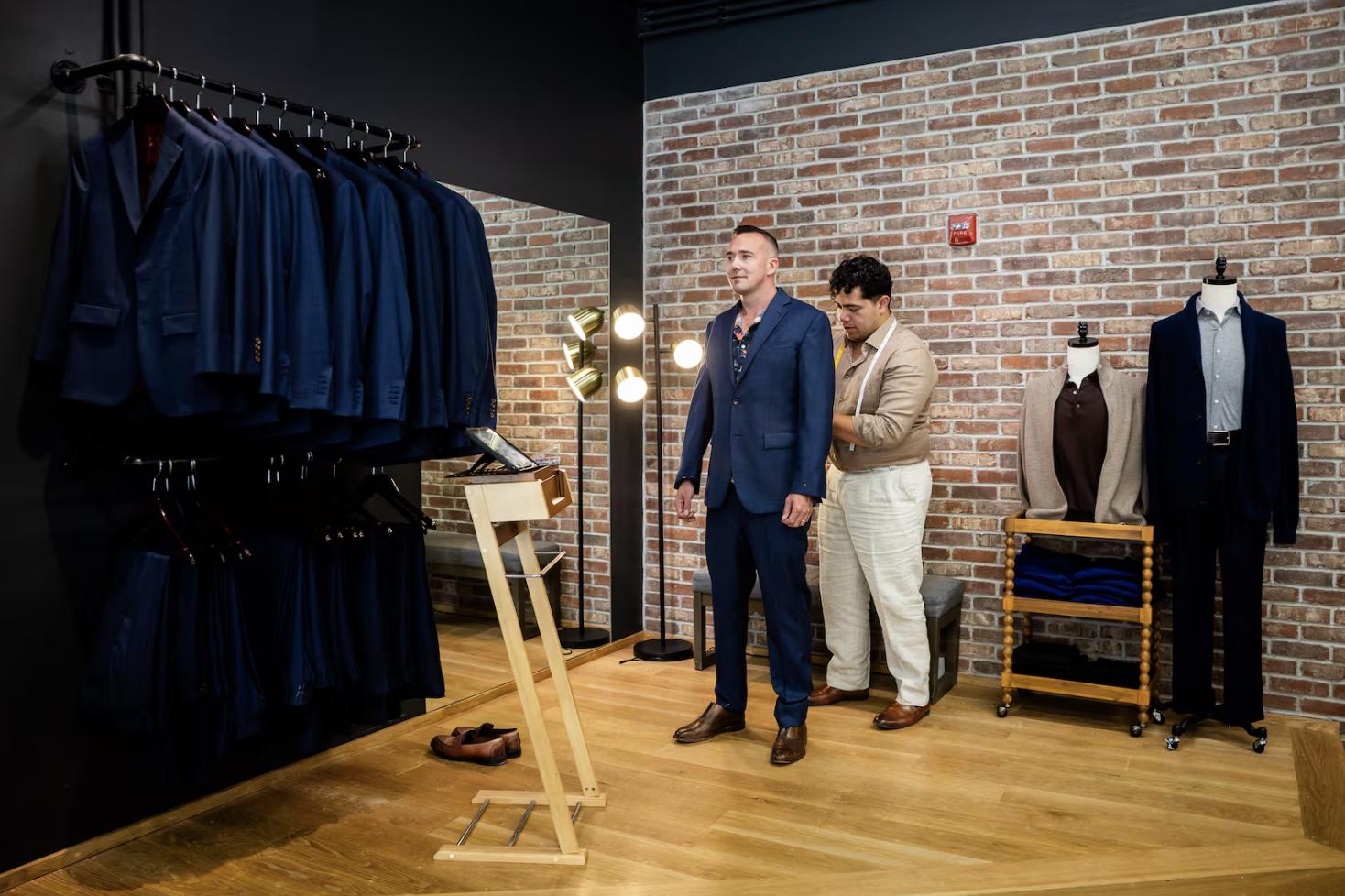 Ikani Iongi, assistant manager, right, fits Shane Hansen, left, for a suit for his wedding at H.M. Cole Custom Suits in Salt Lake City on Aug. 6.