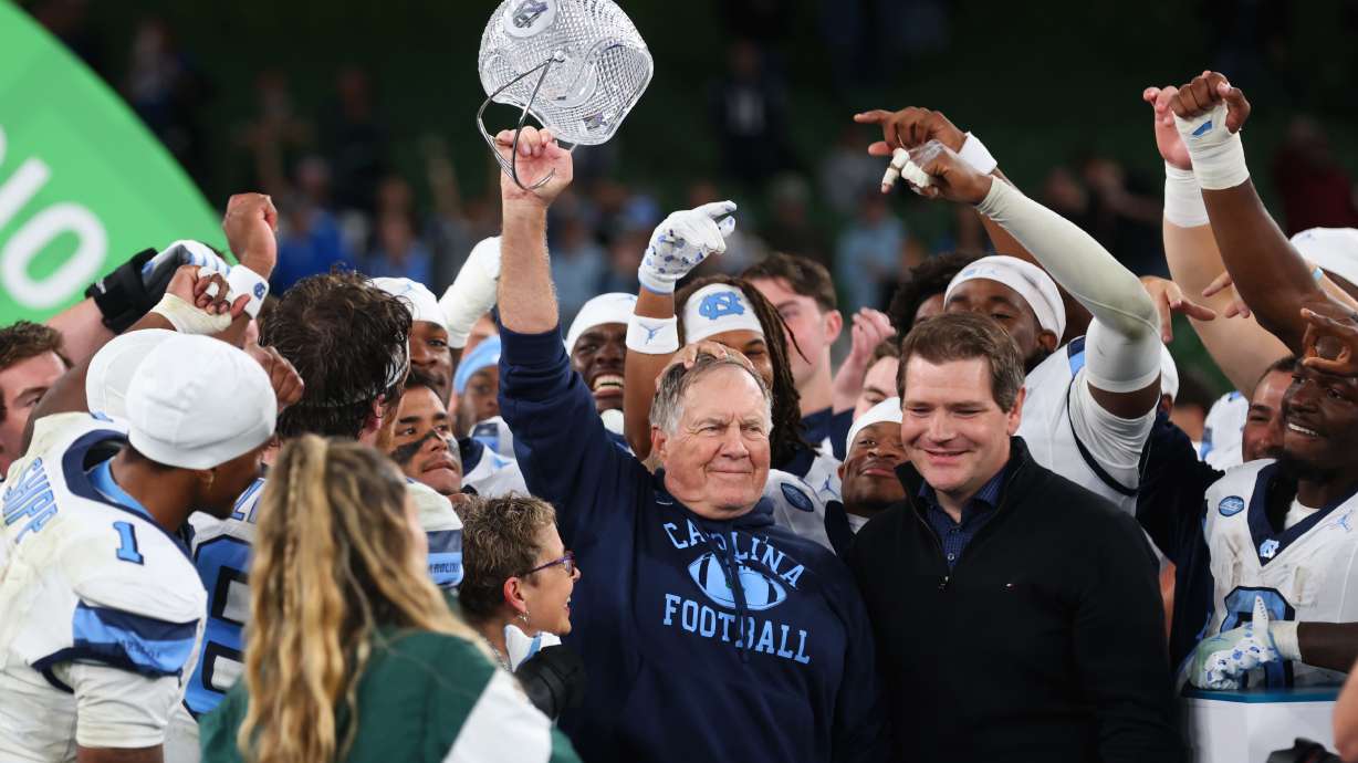 North Carolina head coach Bill Belichick, center, and his team celebrate after defeating TCU in an NCAA college football game in Dublin, Ireland, Saturday, Aug. 29, 2026.