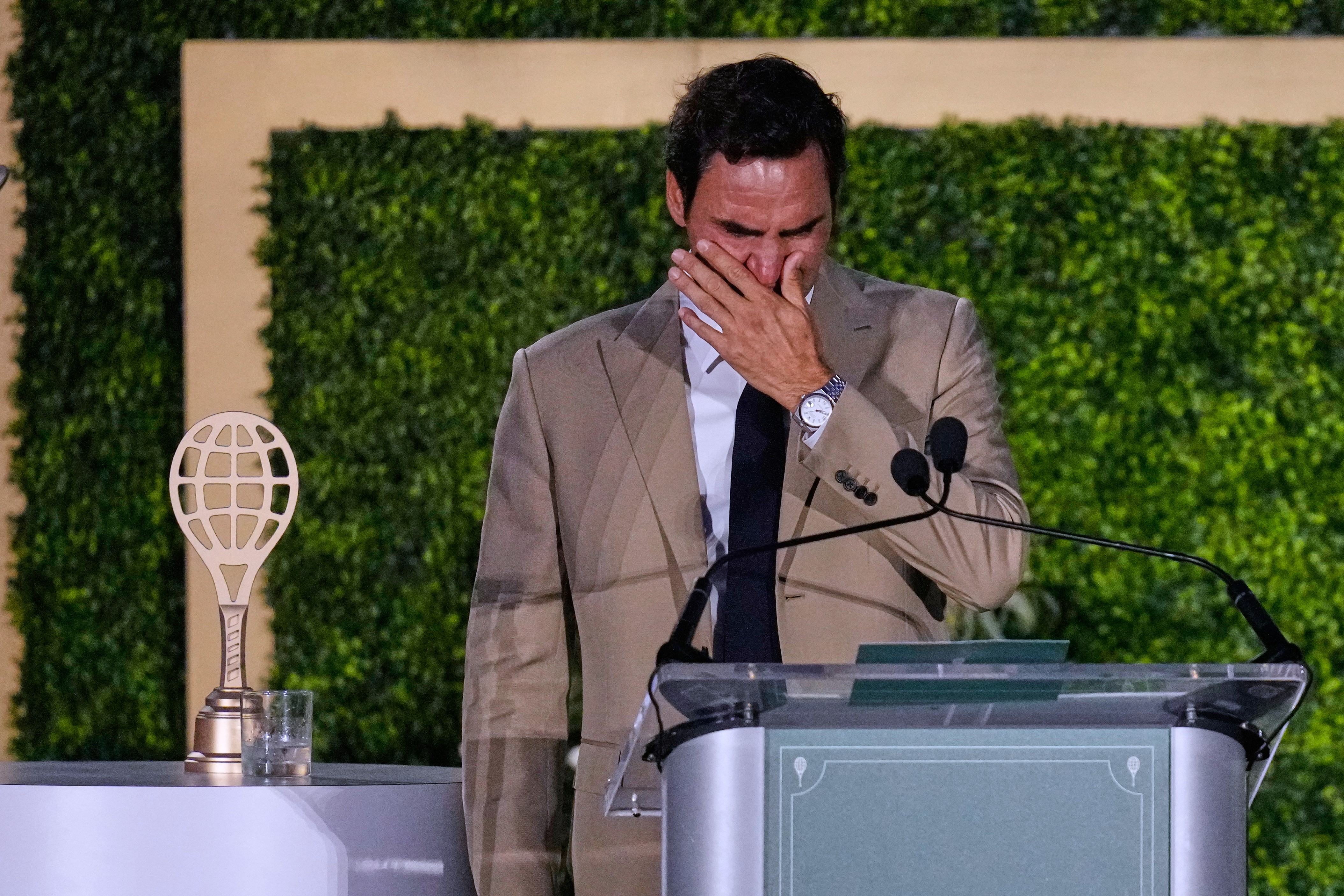 Roger Federer tries to hold back his tears during his induction ceremony at the International Tennis Hall of Fame, Saturday, Aug. 29, 2026, in Newport, R.I. 