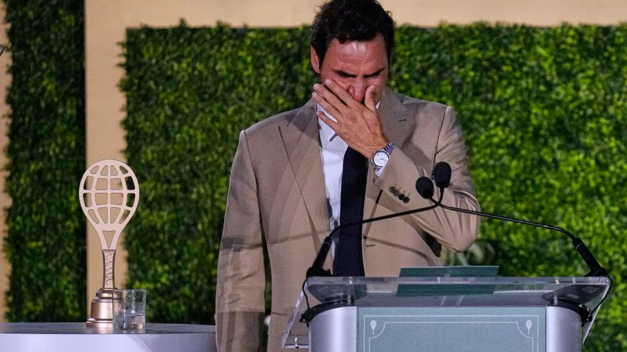 Roger Federer tries to hold back his tears during his induction ceremony at the International Tennis Hall of Fame, Saturday, Aug. 29, 2026, in Newport, R.I.