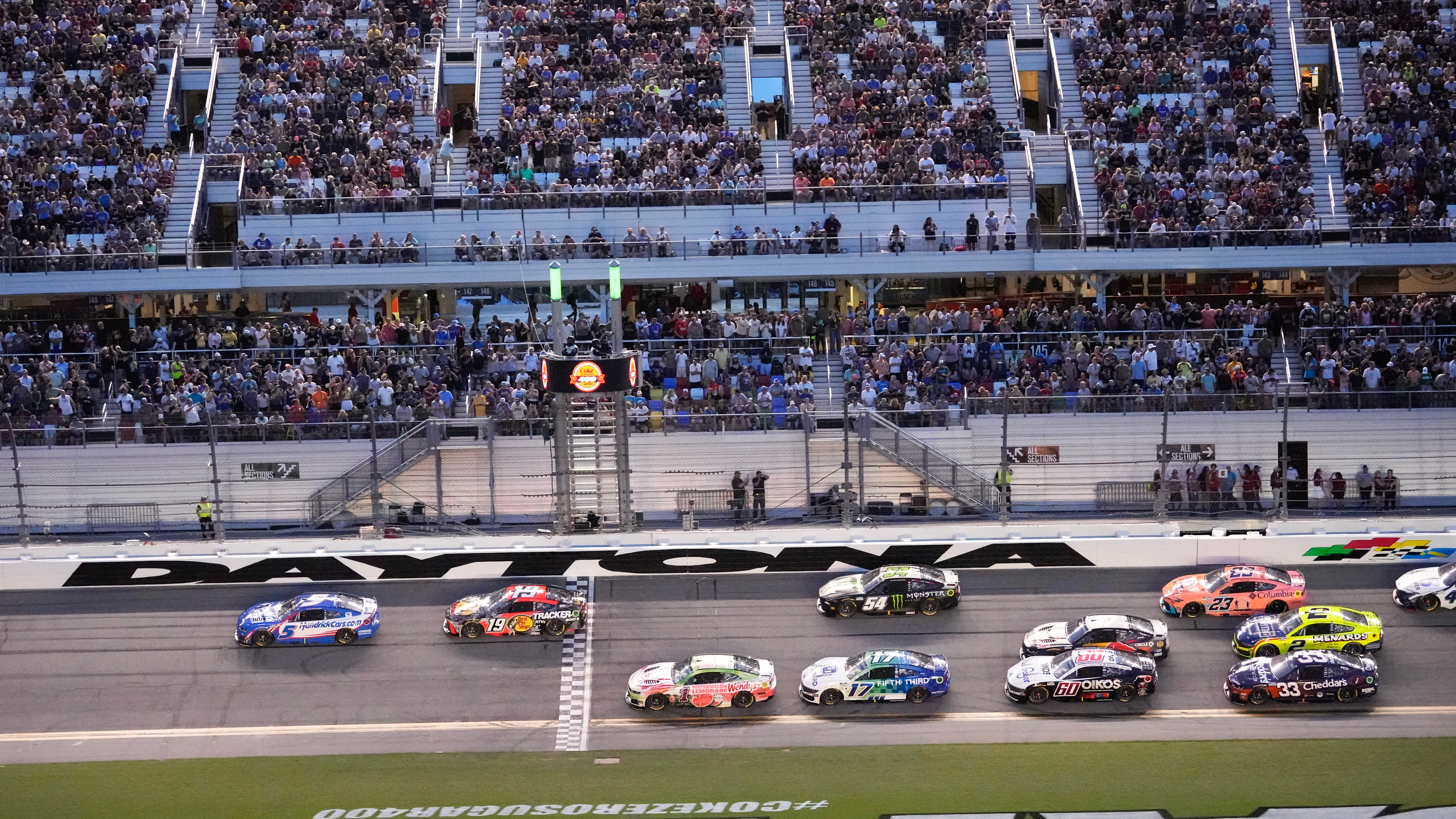 Kyle Larson (5) and Chase Briscoe (19) lead a group through the front stretch during early laps in the NASCAR auto race at Daytona International Speedway, Saturday, Aug. 29, 2026, in Daytona Beach, Fla. 