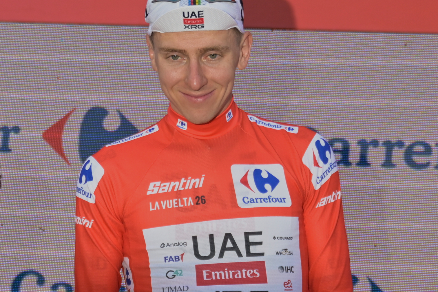 Slovenia's Tadej Pogacar, wearing the overall leader's red jersey celebrates on the podium after the second stage of the La Vuelta cycling race, with start in Monaco and finish in Manosque, France, Sunday, Aug. 23, 2026. 