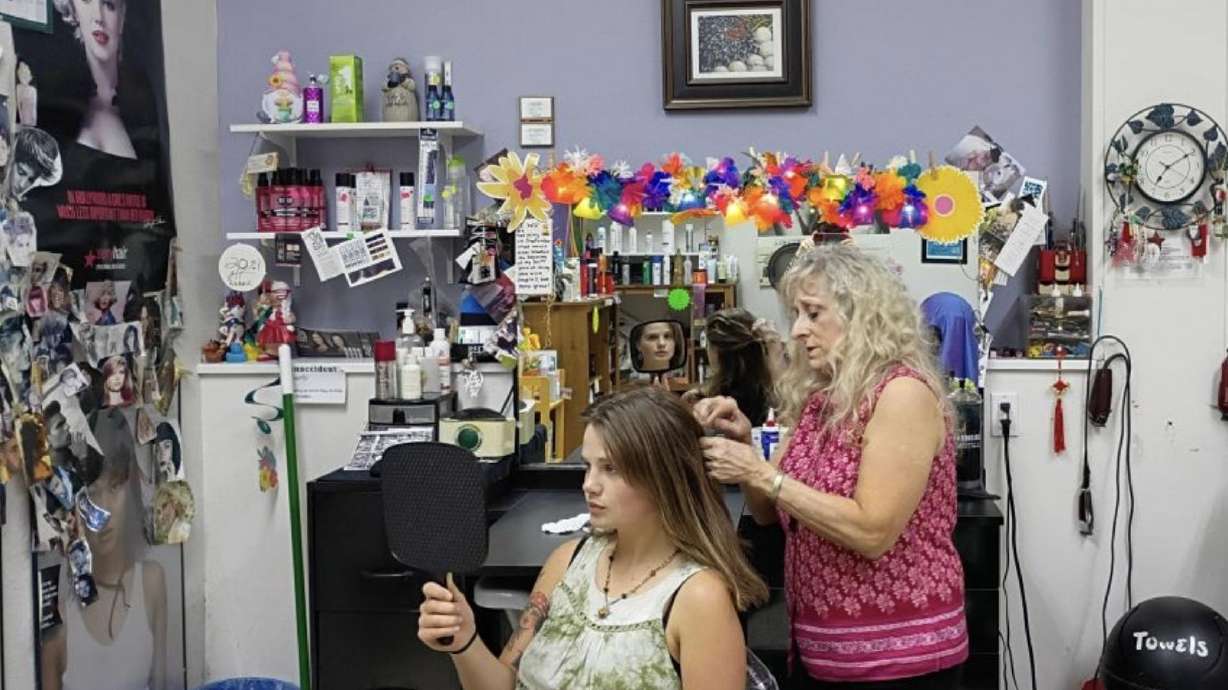 During one of the final days in her hair salon, Natalie Houver consults with client Aleea Melton about wedding hairstyle ideas.
