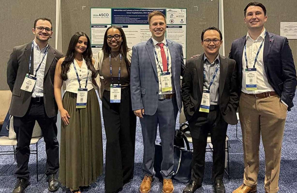 Daniel Thomas Jones, DO, MBA, MHS, with members of his oncology research team at the 2026 ASCO Annual Meeting in Chicago, where the group presented research in cancer outcomes and health services research.