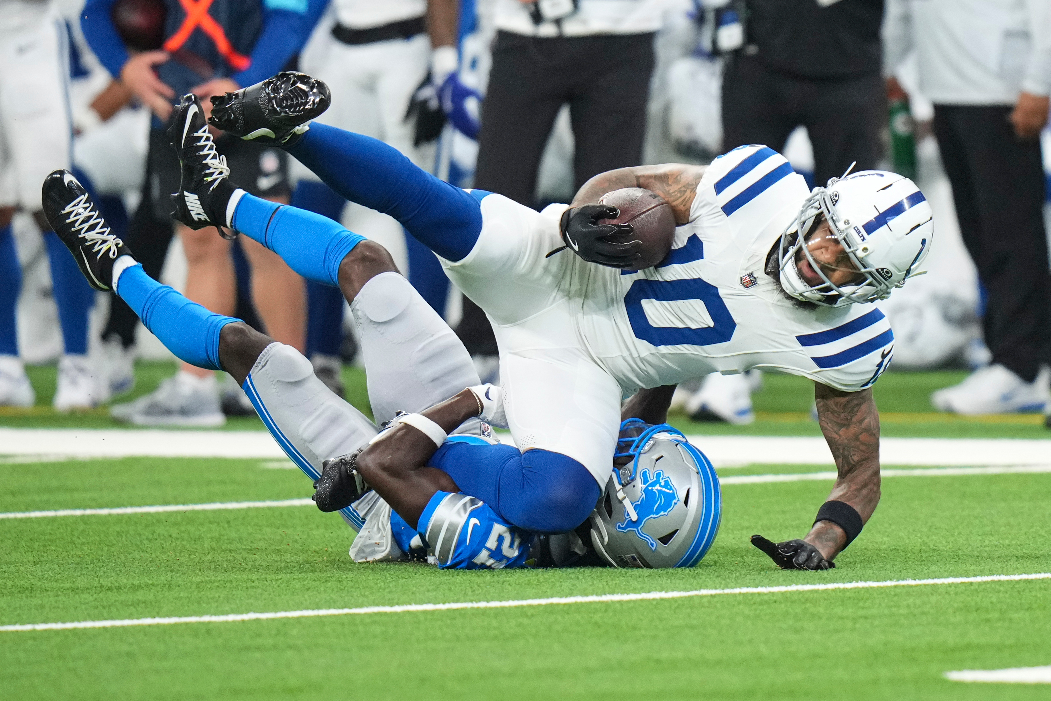 Indianapolis Colts wide receiver Keenan Allen (10) is tackled by Detroit Lions cornerback Roger McCreary (21) during the first half of a preseason NFL football game in Indianapolis, Saturday, Aug. 29, 2026. 