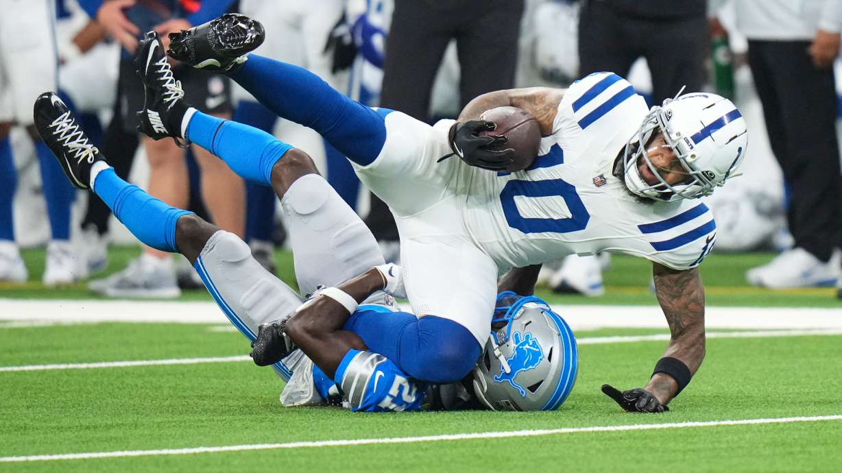Indianapolis Colts wide receiver Keenan Allen (10) is tackled by Detroit Lions cornerback Roger McCreary (21) during the first half of a preseason NFL football game in Indianapolis, Saturday, Aug. 29, 2026.
