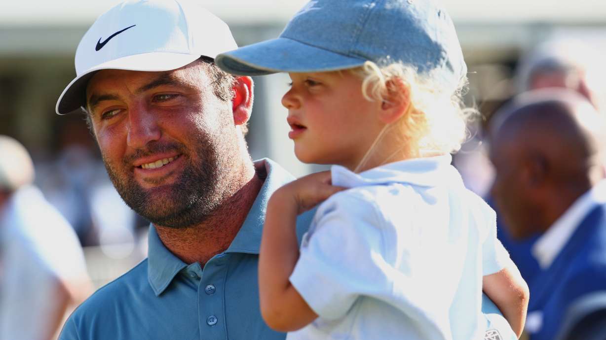 Scottie Scheffler holds his child Bennett after winning the PGA Tour Championship golf tournament Sunday, Aug. 30, 2026, in Atlanta.
