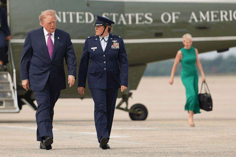 President Donald Trump, left, walks to board Air Force One, followed by White House aide Natalie Harp, background right, Thursday, Aug. 27, 2026, at Joint Base Andrews, Md.