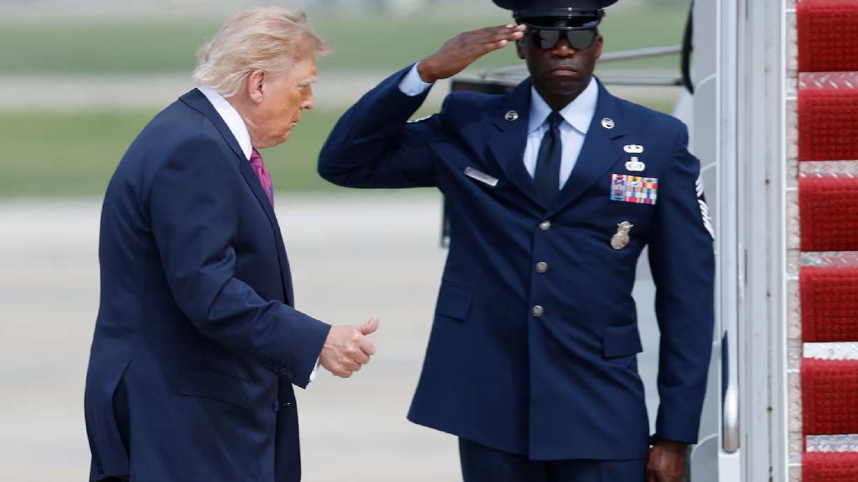 President Donald Trump, left, gestures as he walks from Marine One to board Air Force One, during his departure at Joint Base Andrews, Md., Thursday. President Donald Trump's message to voters ahead of the November midterm election is "pretend I'm on the ballot."