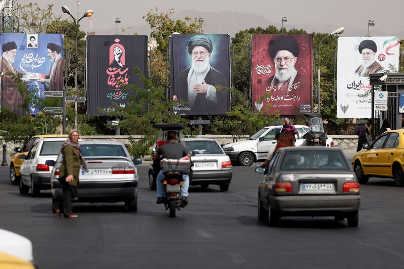 Banners with pictures of the late Supreme Leader of Iran, Ayatollah Ali Khamenei, are displayed on a street in Tehran, Iran, Aug. 22. Iran's rulers are aware of the potential of an economic meltdown due to U.S. sanctions.