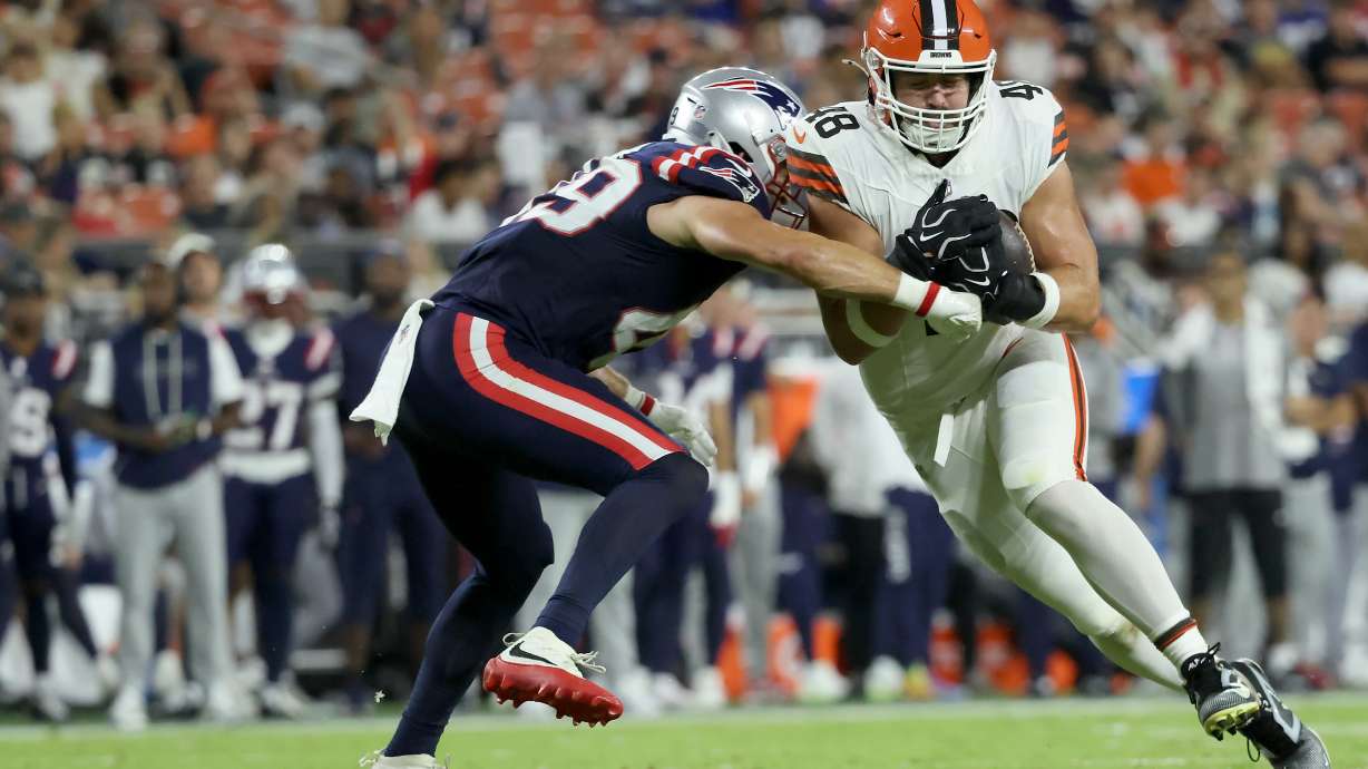 Cleveland Browns tight end Carsen Ryan (48) is tackled by New England Patriots linebacker Chad Muma (49) during an NFL preseason football game in Cleveland, Thursday, Aug. 27, 2026.