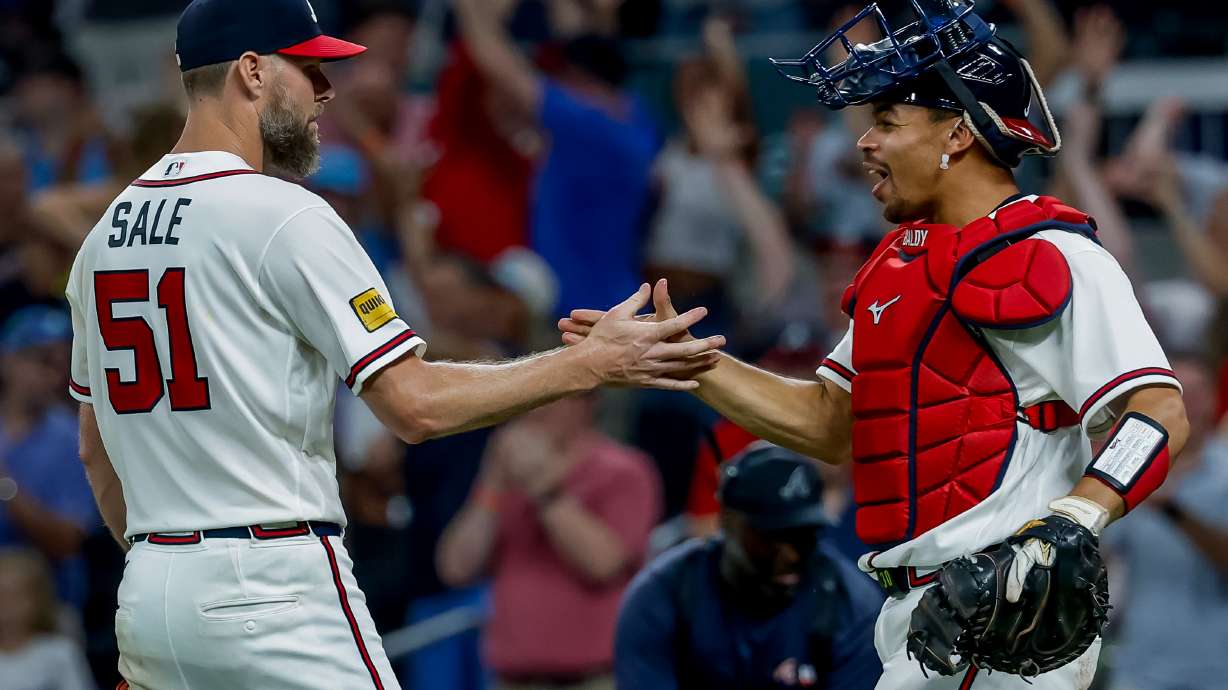 Atlanta Braves pitcher Chris Sale (51) celebrates with catcher Drake Baldwin after Sale won a complete game shutout of the Los Angeles Dodgers during the ninth inning of a baseball game, Thursday, Aug. 27, 2026, in Atlanta.
