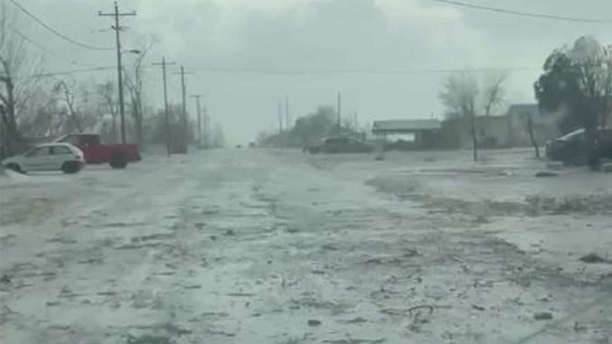 Hail and rain on a road in Lynndyl, Millard County, after an intense storm hit the area on Saturday. More flooding and active weather are forecast for most of Utah on Monday.