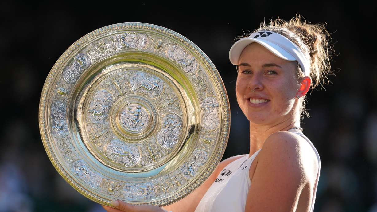 FILE - Linda Noskova of the Czech Republic poses with the trophy after winning against Karolina Muchova of the Czech Republic in the women's singles final at Wimbledon Tennis Championships in London, July 11, 2026.