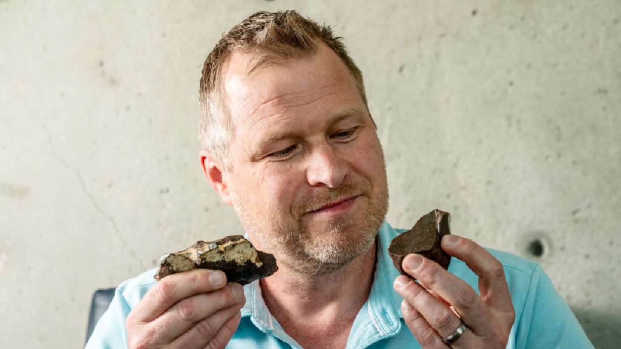 James Karner, a research professor in the Department of Geology and Geophysics at the University of Utah, examines fragments of the Great Salt Lake meteorite, which crashed along the south shore in 2022.