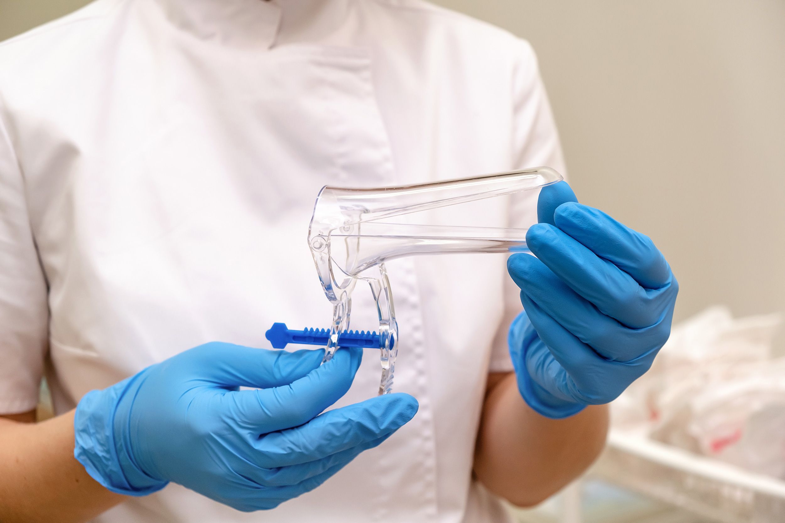 In a traditional screening, a clinician uses a speculum to collect a sample during a pelvic examination.