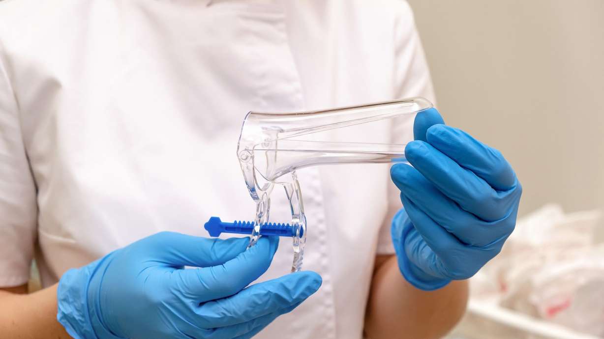 In a traditional screening, a clinician uses a speculum to collect a sample during a pelvic examination.