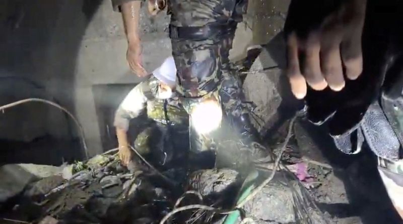 Rescue personnel work at a hydropower tunnel site in the aftermath of deadly flash floods and a mudslide, in Rasuwa district, Nepal, in this still image obtained from a social media video released on Monday. Aid worth over $42 million has already arrived in the country, Prime Minister Balendra Shah said on Tuesday.