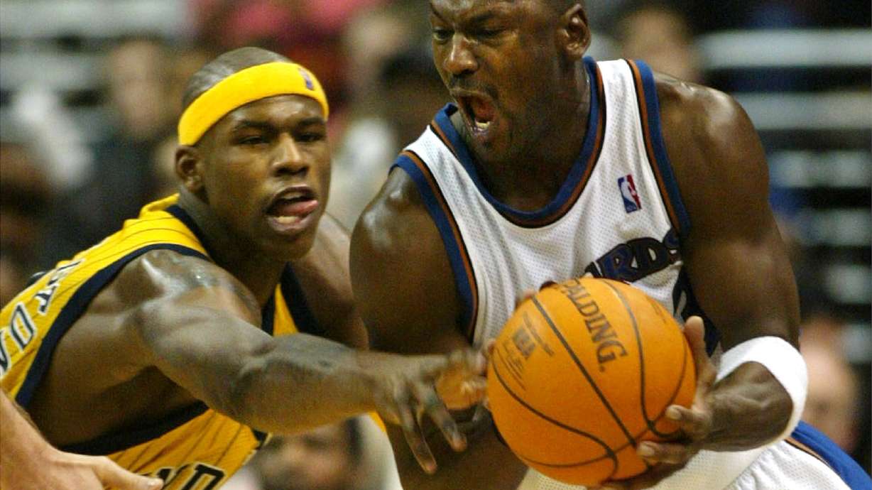 FILE - Washington Wizards' Michael Jordan gets control of the ball with pressure from Indiana Pacers' Al Harrington in the fourth quarter of play, Jan. 4, 2003, in Washington.