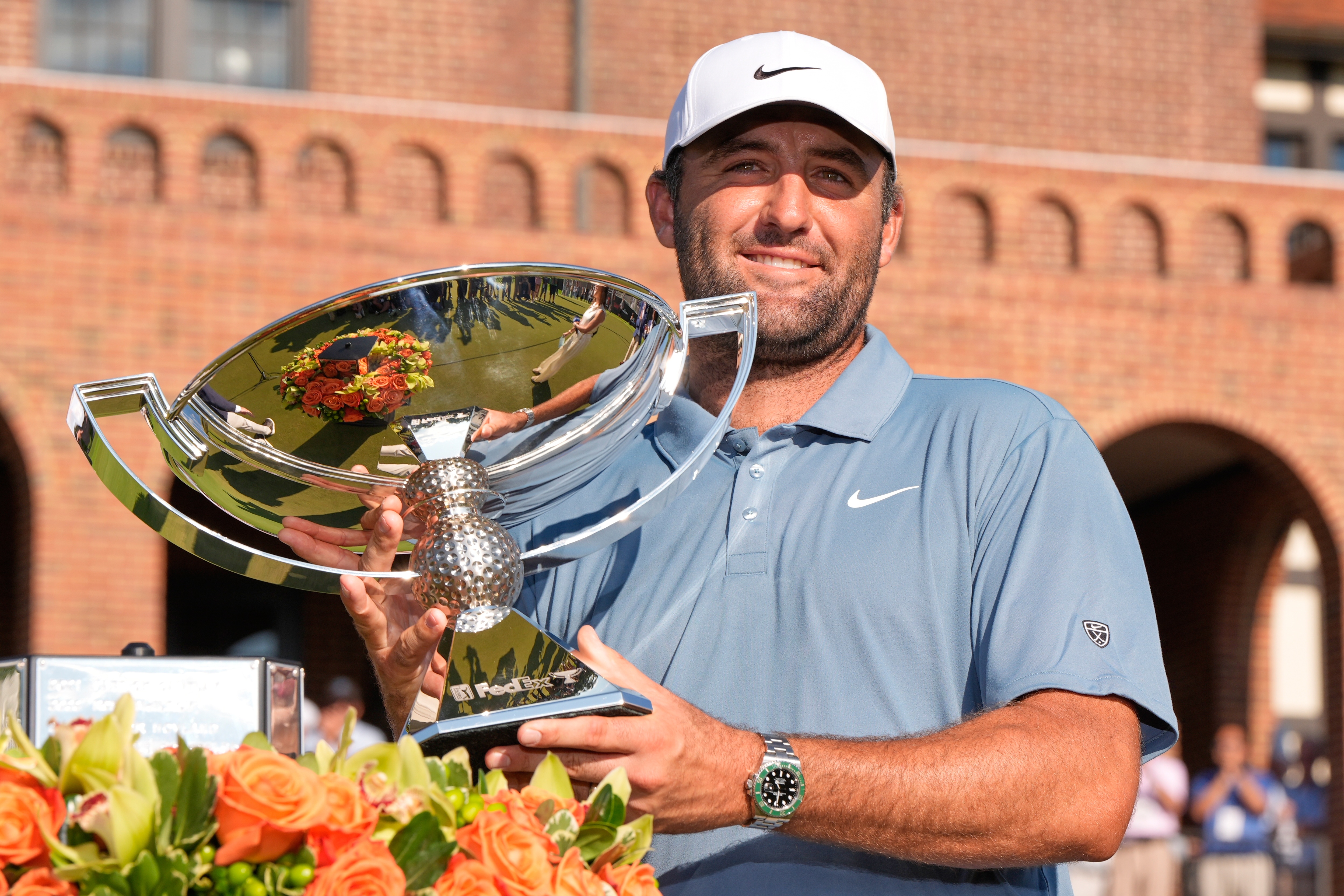 Scottie Scheffler holds the trophy after winning the PGA Tour Championship golf tournament Sunday, Aug. 30, 2026, in Atlanta. 