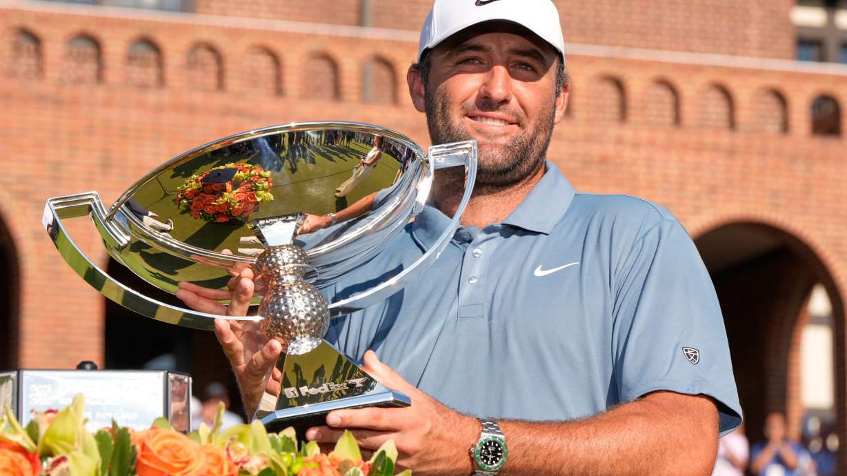 Scottie Scheffler holds the trophy after winning the PGA Tour Championship golf tournament Sunday, Aug. 30, 2026, in Atlanta.