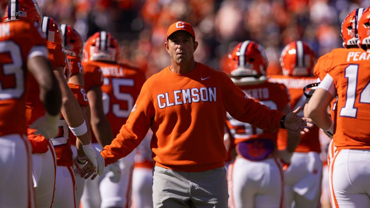 FILE - Clemson head coach Dabo Swinney greets his team before an NCAA college football game against Duke, Nov. 1, 2025, in Clemson, S.C.