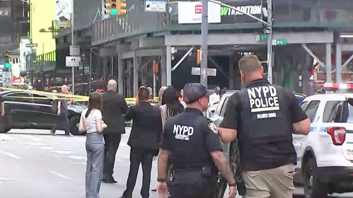 This image made from video provided by WABC shows NYPD officers on the scene after a woman brandishing two large knives was shot by officers in Times Square in New York, Monday, Aug. 31, 2026.