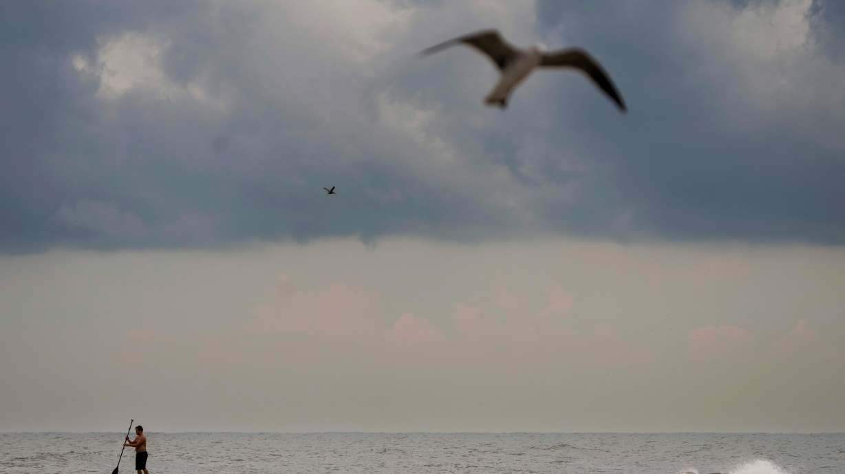 Dark clouds hang low over the horizon as Tropical Storm Edouard makes its way towards landfall in Galveston, Texas, Tuesday. The storm made landfall on the Gulf Coast near the Texas-Louisiana border.