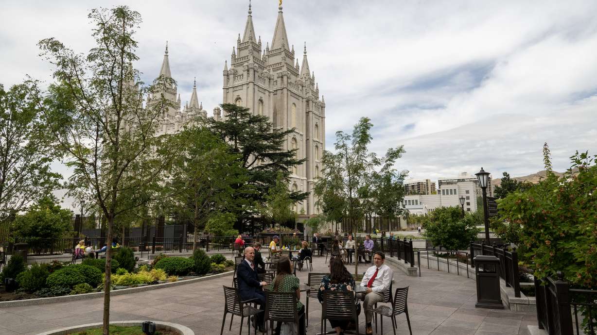 People sit and eat and talk near the the Salt Lake Temple in Salt Lake City on Sept. 1. Transportation options for next year's open house are still being figured out, but Fairpark residents were given a big update on Thursday.