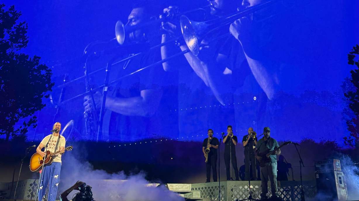 Noah Kahan in Sandy on Aug. 25 with his horn section made up of Utahns Candido Abeyta on the saxophone, Tom Young on the trumpet and trombonist Marcus Anderson.