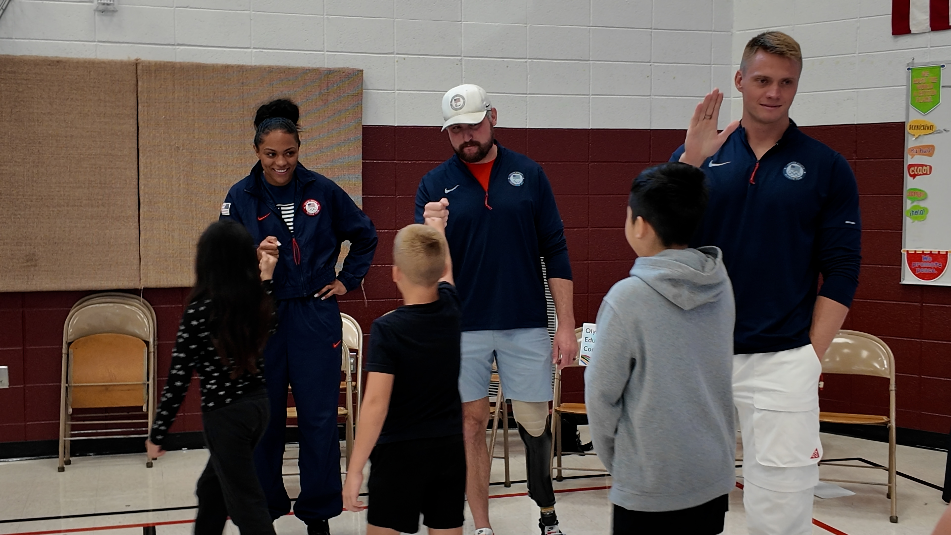 Left to right: Kaysha Love, Joe Pleban, and Hunter Powell greet students at Backman Elementary.