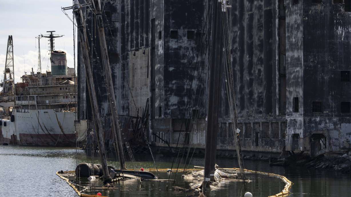 Debris of the Victory Chimes and the Pilot floats in the Henry Street Basin, Wednesday, Aug. 26, 2026, in the Brooklyn borough of New York.